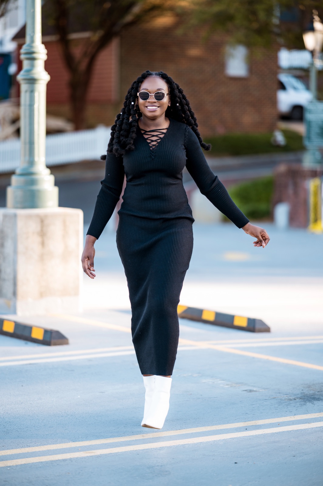Black ribbed dress, white boots, urban street
