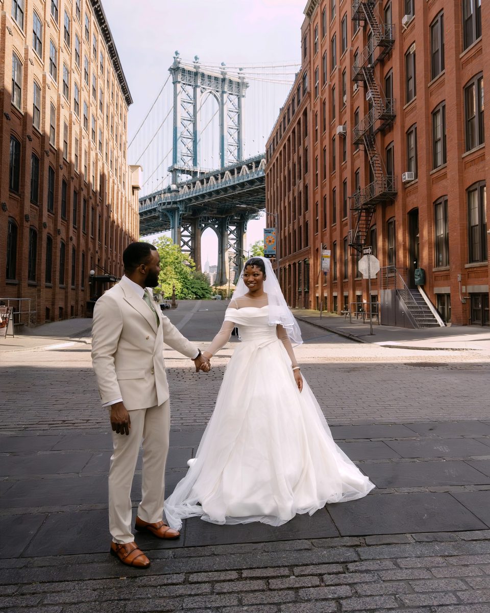 Bride and groom on a cobbled Dumbo street below the Manhattan Bridge