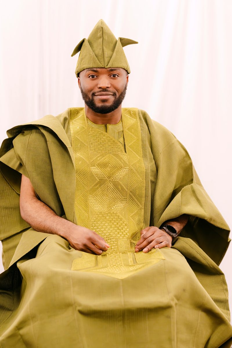Groom in olive agbada, seated
