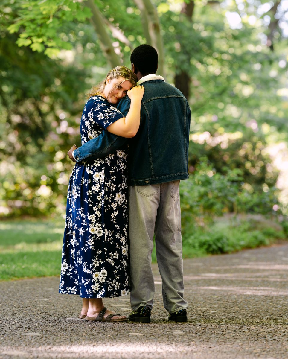Couple embracing on a garden path