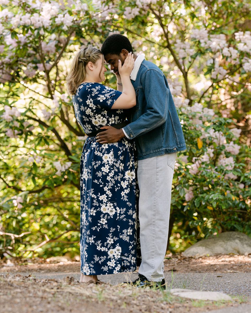 Couple embracing among rhododendrons