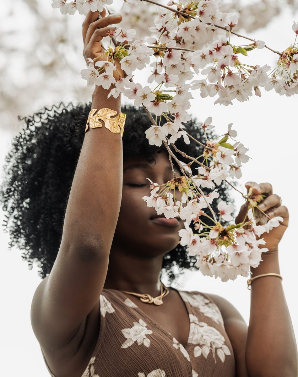 Face hidden among cherry blossom branches