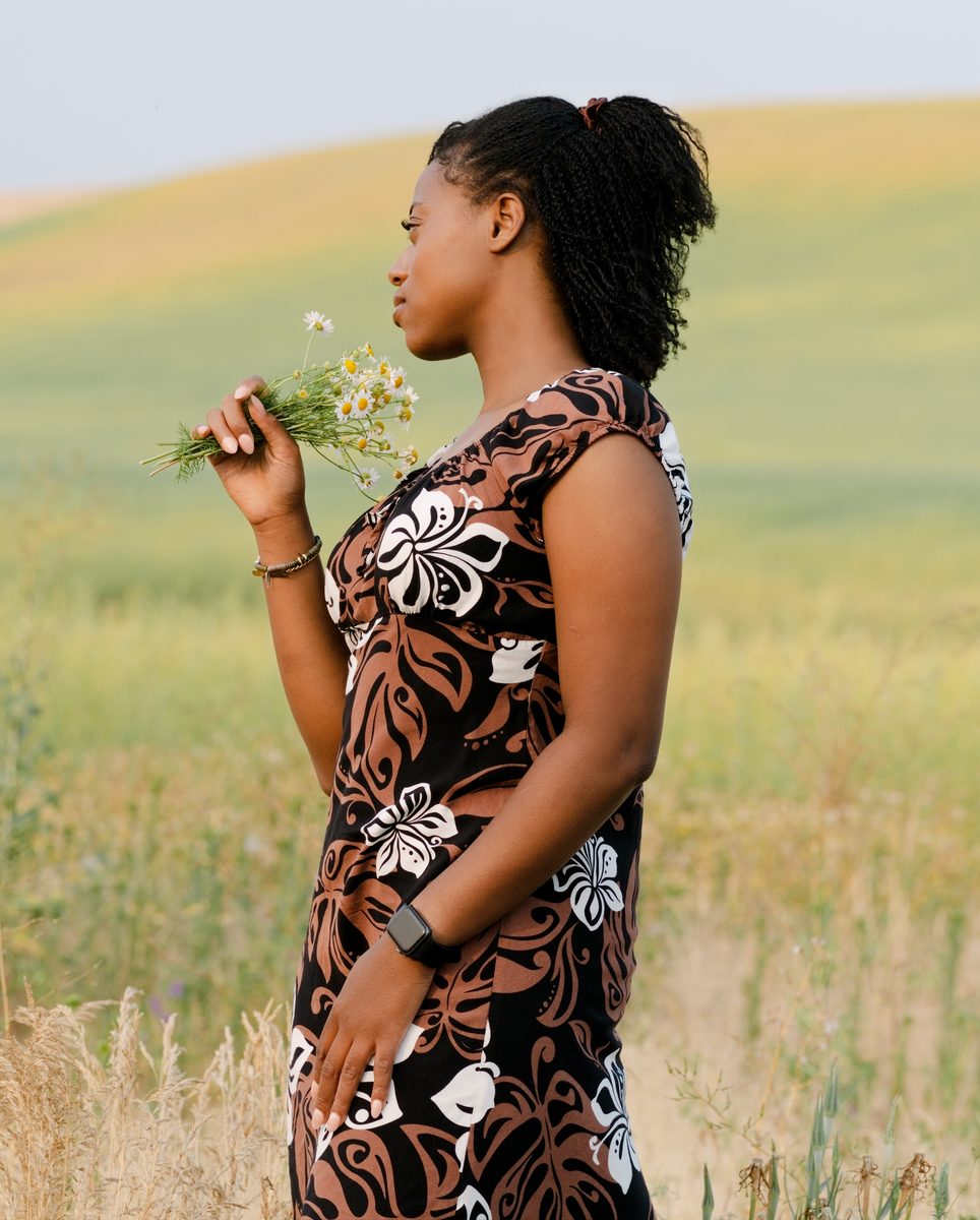 Profile with wild daisies against rolling wheat hills