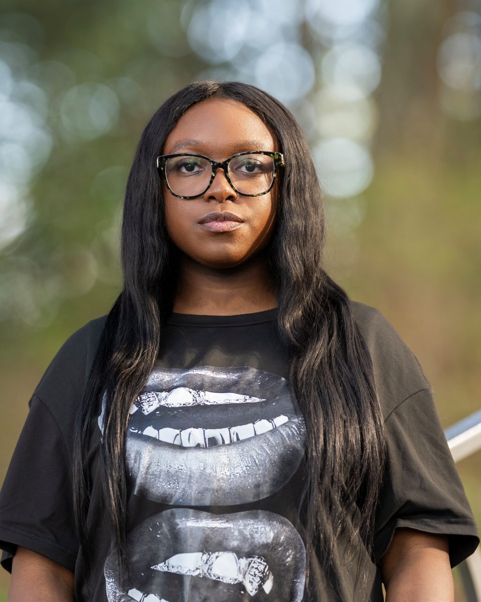 Graphic tee and glasses against forest green