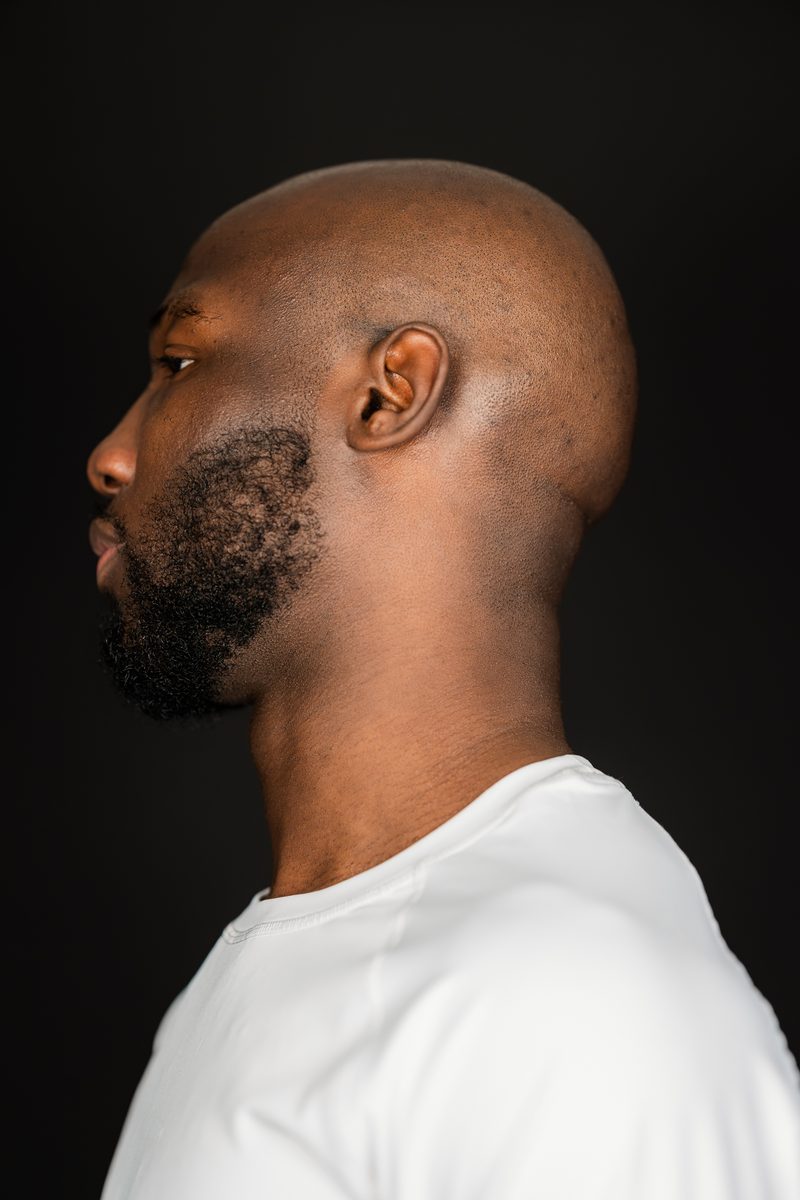 Profile portrait in a white T-shirt on black
