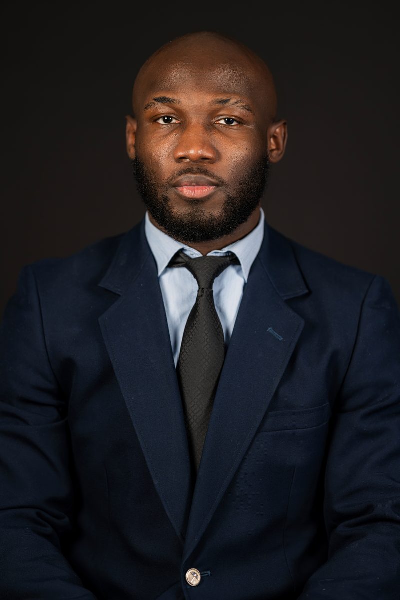 Navy suit and tie on a dark backdrop