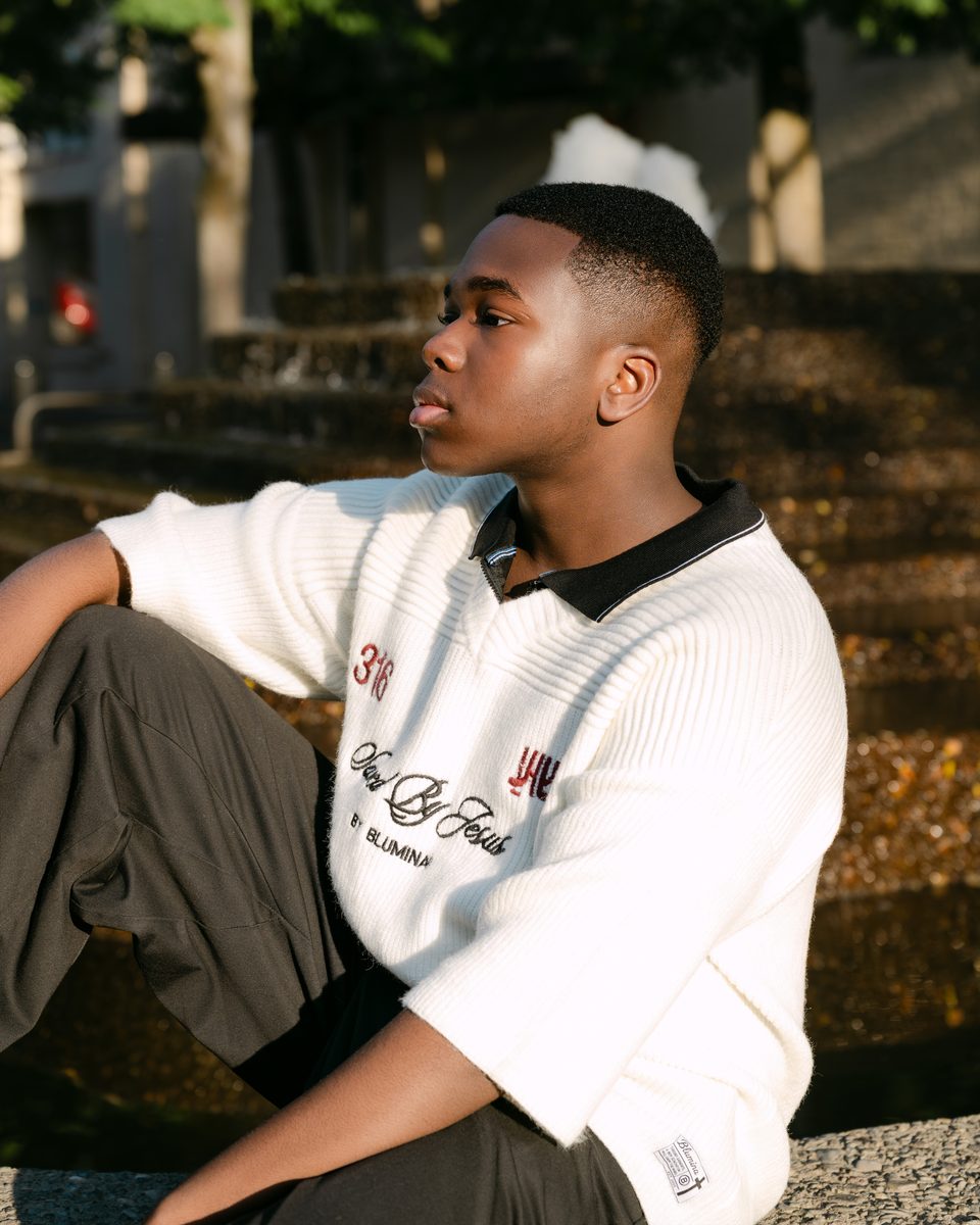 Collared knit polo in golden-hour light by a fountain